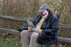 Douglas Bean plays The Clown and reads the paper while waiting for the shot to be set up