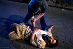 Juan (Eddie Martinez) trying to stop Cesar's (Karman Bajuyo) bleeding wound