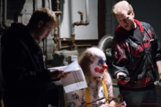 Director Joe Goudreault going over notes while Douglas Bean (plays The Clown) gets metered for lighting